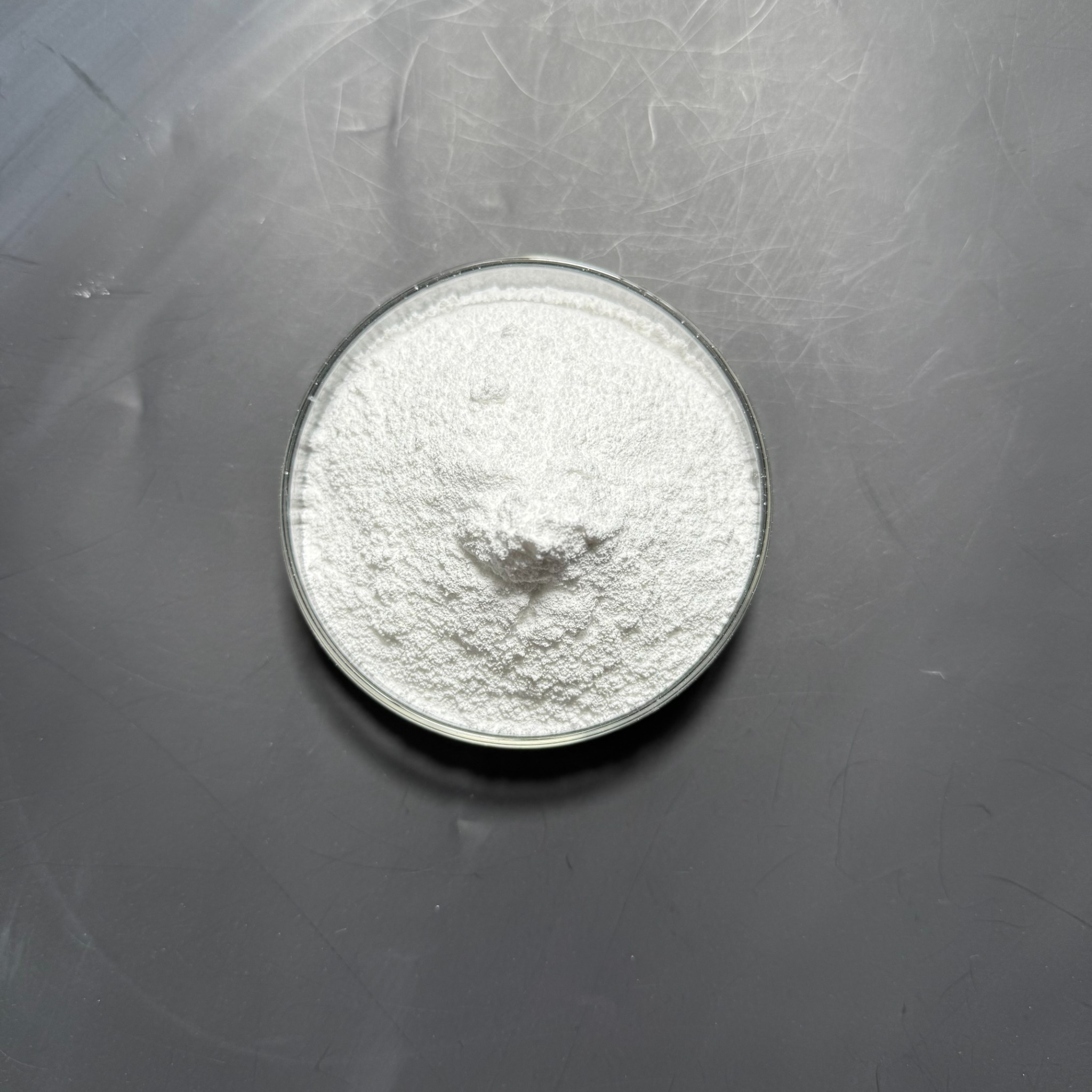 Magnesium oxide white powder in a glass dish